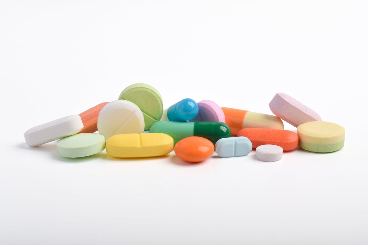 Various colorful pills and capsules isolated on white background
